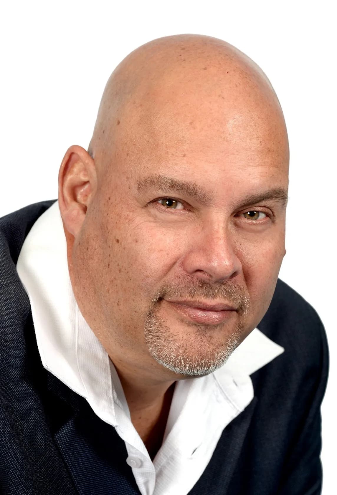 Portrait of Thomas Lee in a navy jacket and an open white shirt.